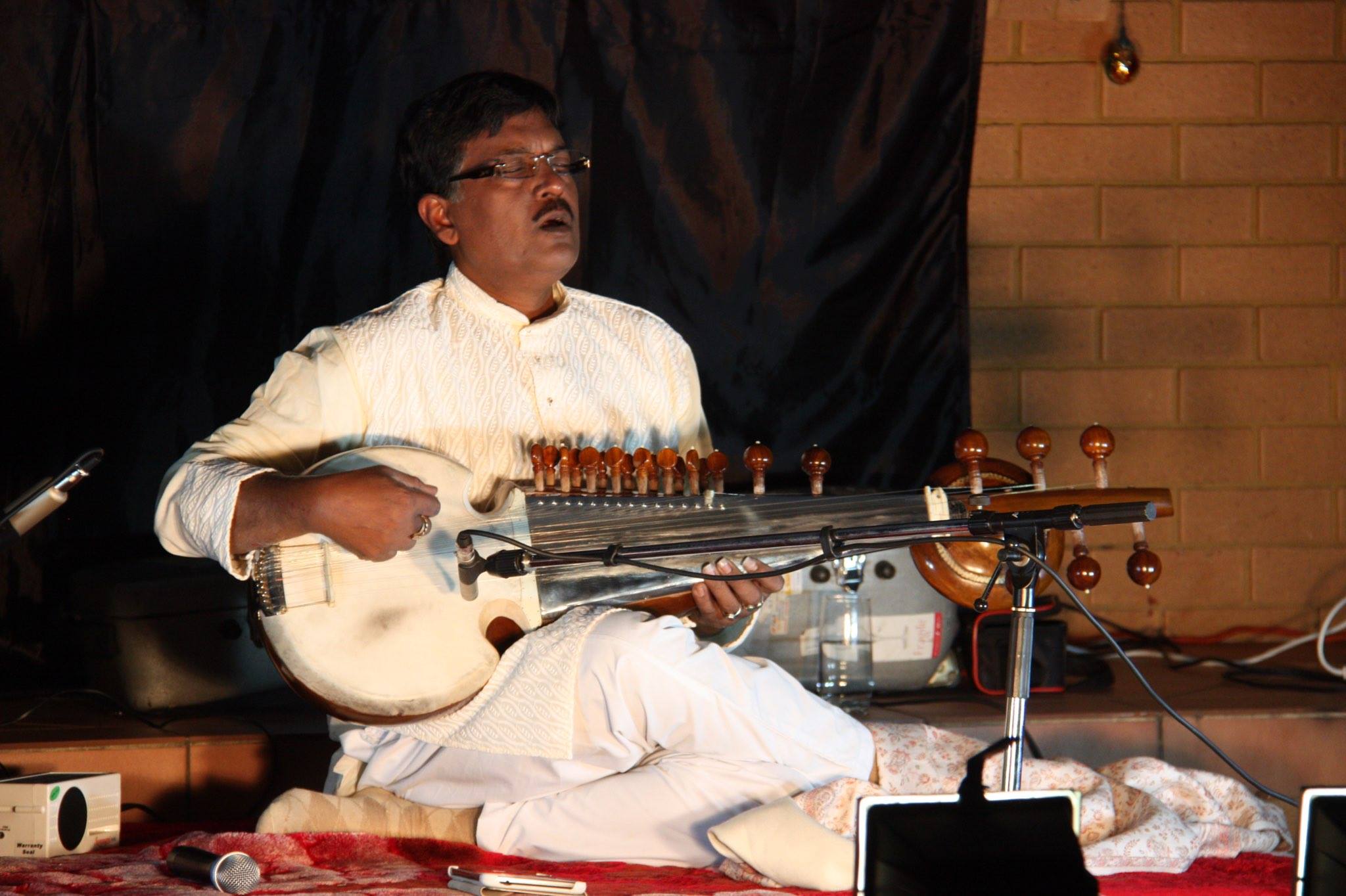 Debashish Bhattacharya playing a music instrument