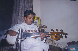 A man playing an instrument in his living room.