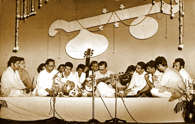 A group of people sitting on top of a stage.