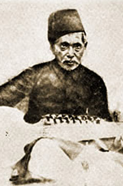 A man sitting in front of an instrument.